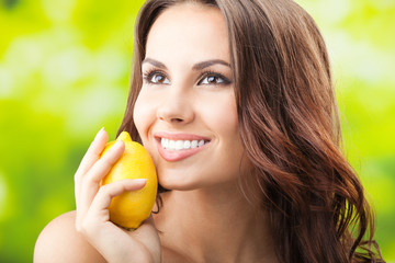 Young happy smiling woman with limon, outdoors