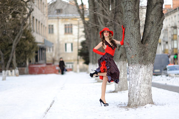 attractive girl in red hat outdoor on the snow