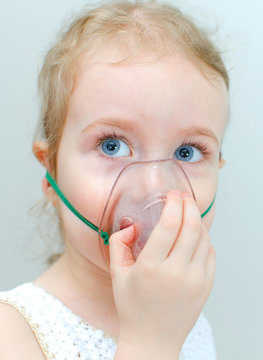 Portrait of little girl with inhalator mask on the face