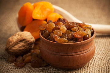 dried fruit on a wooden spoon on a burlap