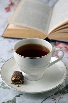 With a Cup of tea on a stack of books