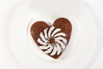 Brown heart shaped cookie with sugar powder