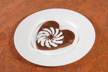 Brown heart shaped cookie with sugar powder