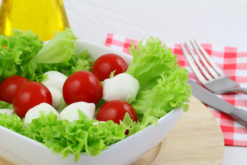 Salad with mozzarella, cherry tomatoes and lettuce