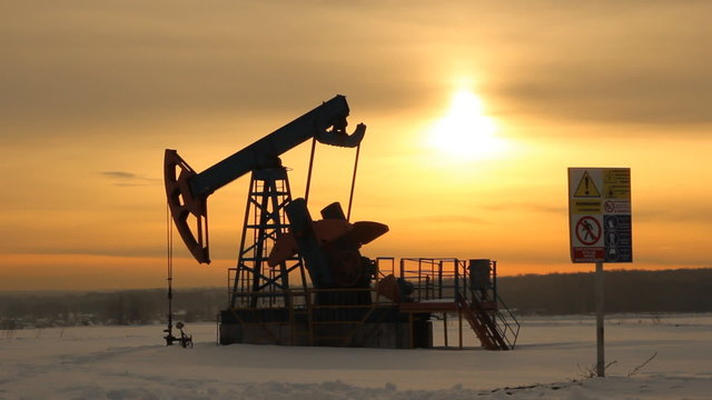 Oil production. Oil pumps at sunset 