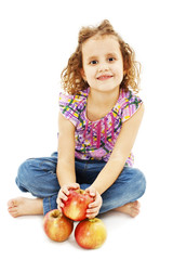 Portrait of a cute little girl with three apples