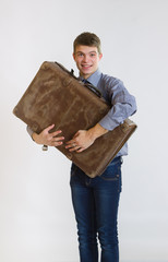 Young businessman embracing his old suitcase