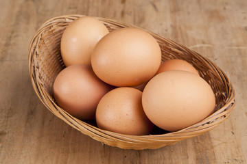 eggs in a bascket on wooden table