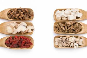 chinese herbs on wooden spoons, symmetric composition