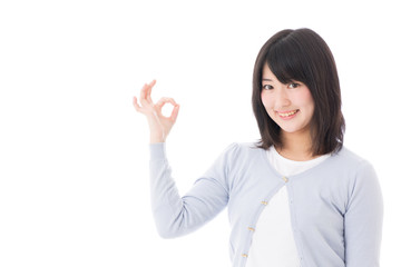 a young asian woman showing ok sign on white background
