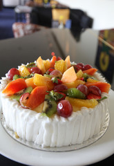 mixed tropical fruit cake with papaya, kiwi, grape and orange