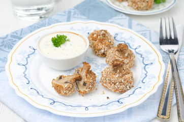 appetizer of fried mushrooms with yoghurt sauce