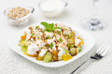 fruit salad with nuts, yogurt and mint