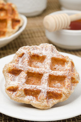 homemade waffles topped with powdered sugar for breakfast