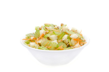 salad with celery, carrots and apples in a white bowl isolated