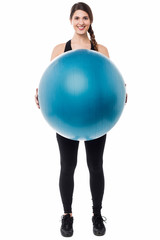 Gym girl presenting a swiss ball