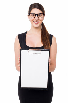 Cute business executive showing blank clipboard