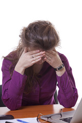 Tired businesswoman at an office desk isoalted on white