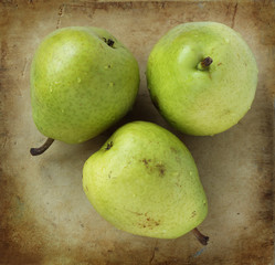 Organic pears on an old rustic stone chopping board