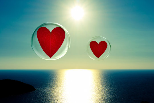 Two floating hearts in bubbles