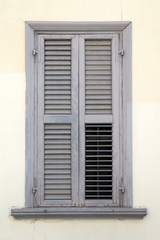 Old locked window in vintage wall