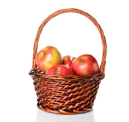 Apples in a brown basket on a white background