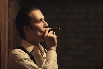 Portrait of young gangster with cigar