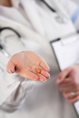 Obraz na płótnie Canvas Doctor showing a pill
