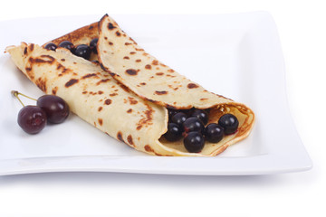 Pancake with berries isolated white. close-up