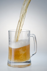 Beer being poured into a mug from a bottle