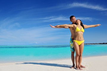 happy young  couple enjoying summer on beach