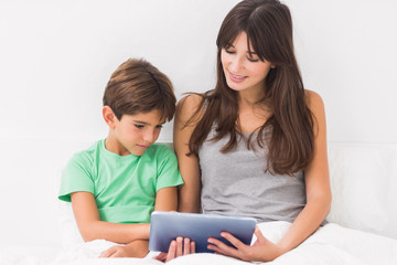 Fototapeta premium Mother and son using tablet pc