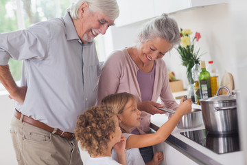 Children cooking with grandparents