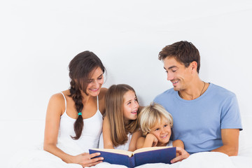 Family sitting with a book