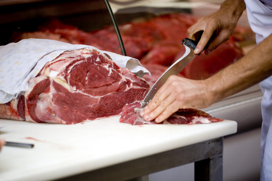 butcher cutting meat
