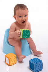 baby boy sitting on potty - obrazy, fototapety, plakaty
