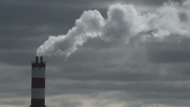 Smoke industrial tube on moody sky background