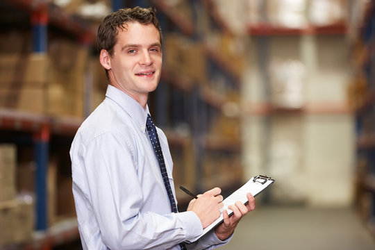 Portrait Of Manager In Warehouse With Clipboard