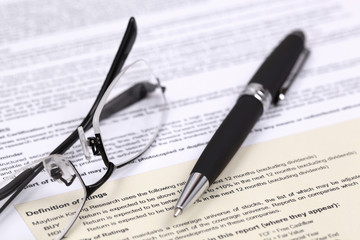 Eye glasses and document with pen