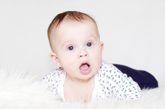 Portrait of the five-months surprised baby