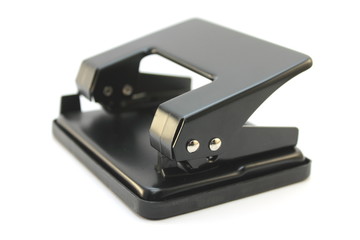 Black office hole punch on a white background
