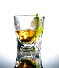 Tuinposter Limoenfruit in Tequila Shot Glass © Donald Bowers