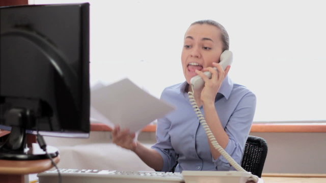 Businesswoman screaming  by telephone, slow motion