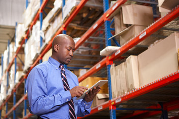 Businessman With Digital Tablet In Warehouse