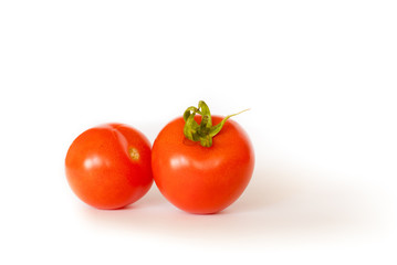 Two tomatoes isolated on white background