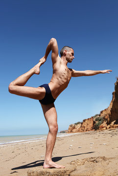 Man doing yoga pose king of dances