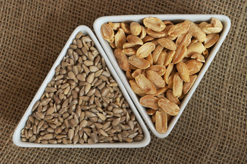 Peanuts and sunflower seeds in two triangular bowls
