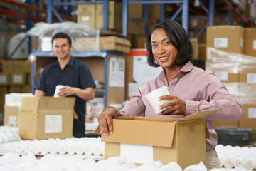 Manager Checking Goods On Production Line