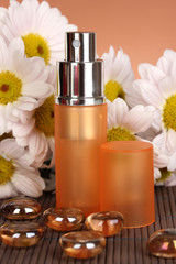 Women's perfume in beautiful bottle with camomiles