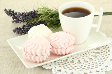 Marshmallows on plate on light background
